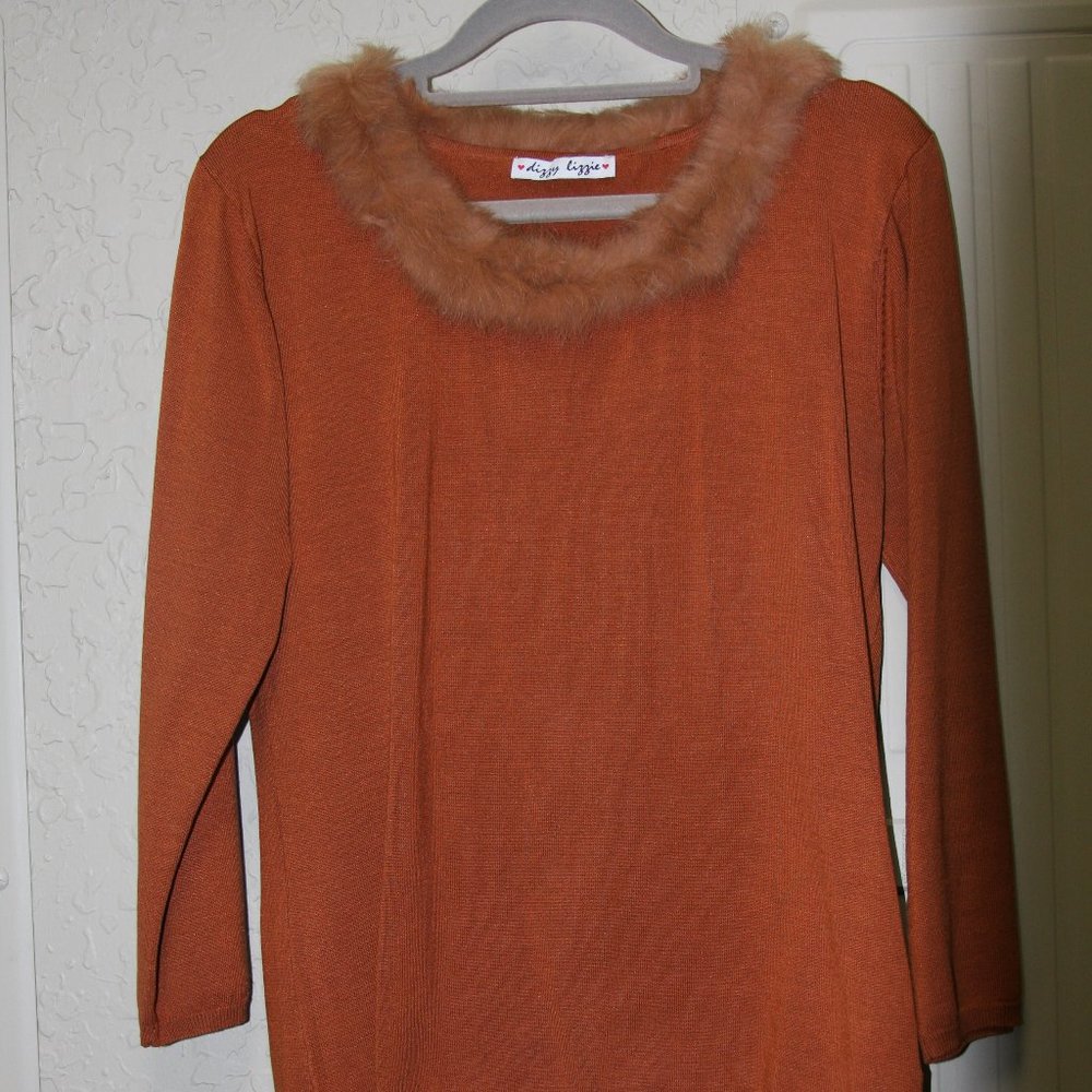 Sweater with round neck accented with elegant fur trim.